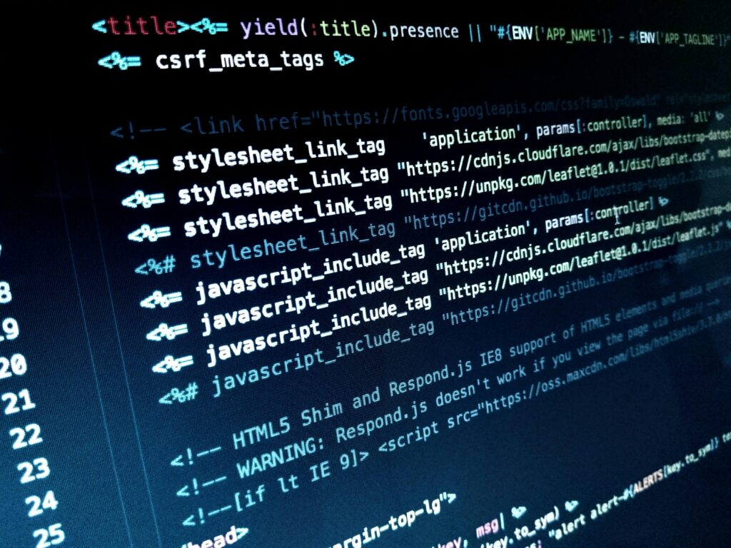 Close-up of color-coded programming code on a dark screen, showing JavaScript/HTML terms and syntax highlighting.