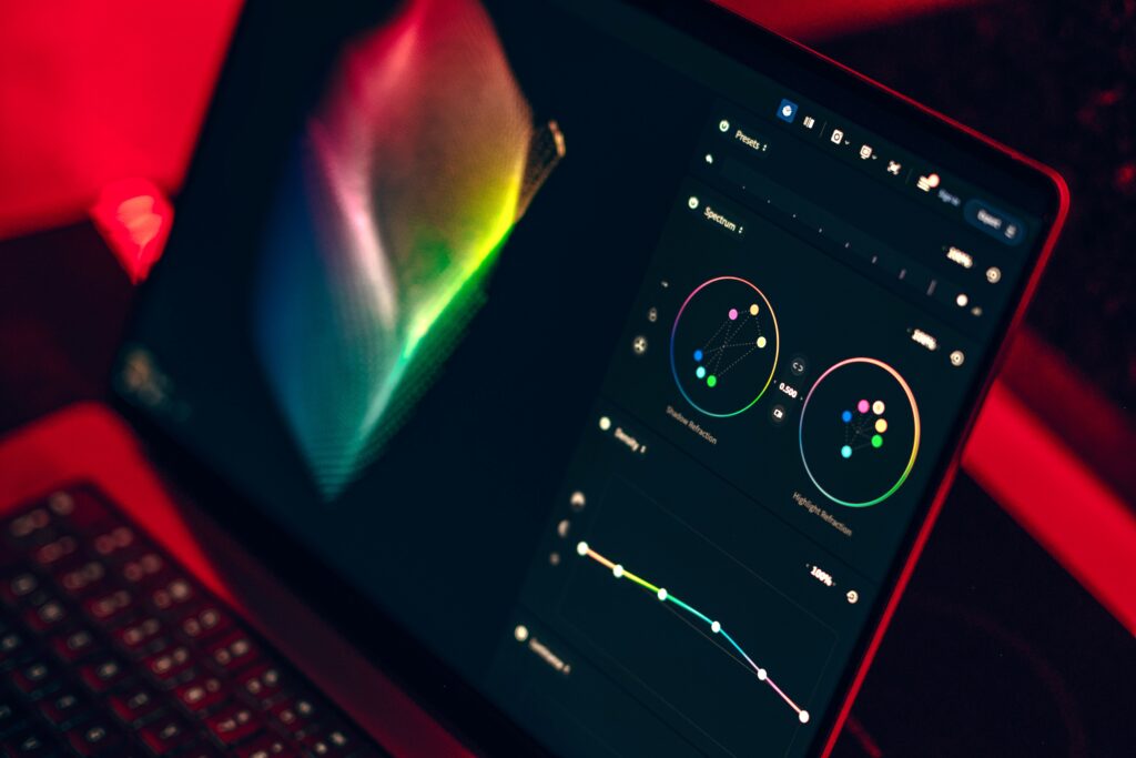Tablet screen displaying colorful circular network graphs and a dark data visualization UI in neon lighting